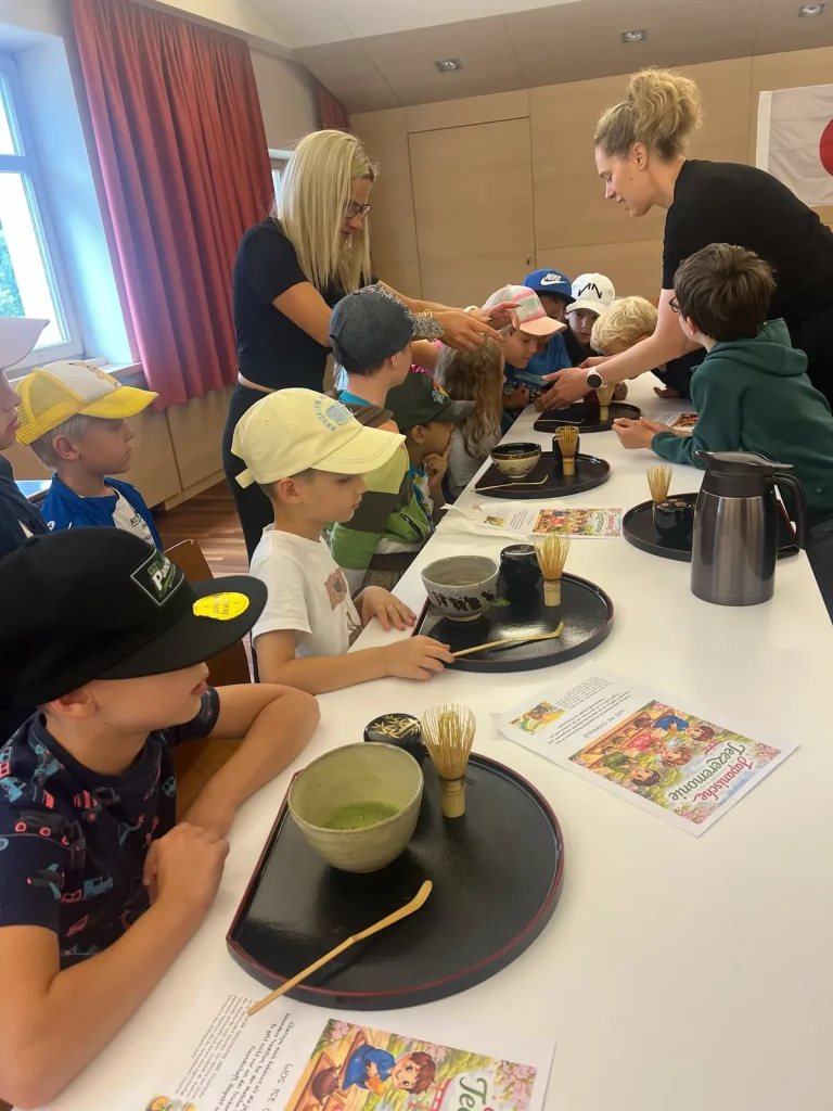 Children taking part in a matcha-making experience in Kitzbühel.